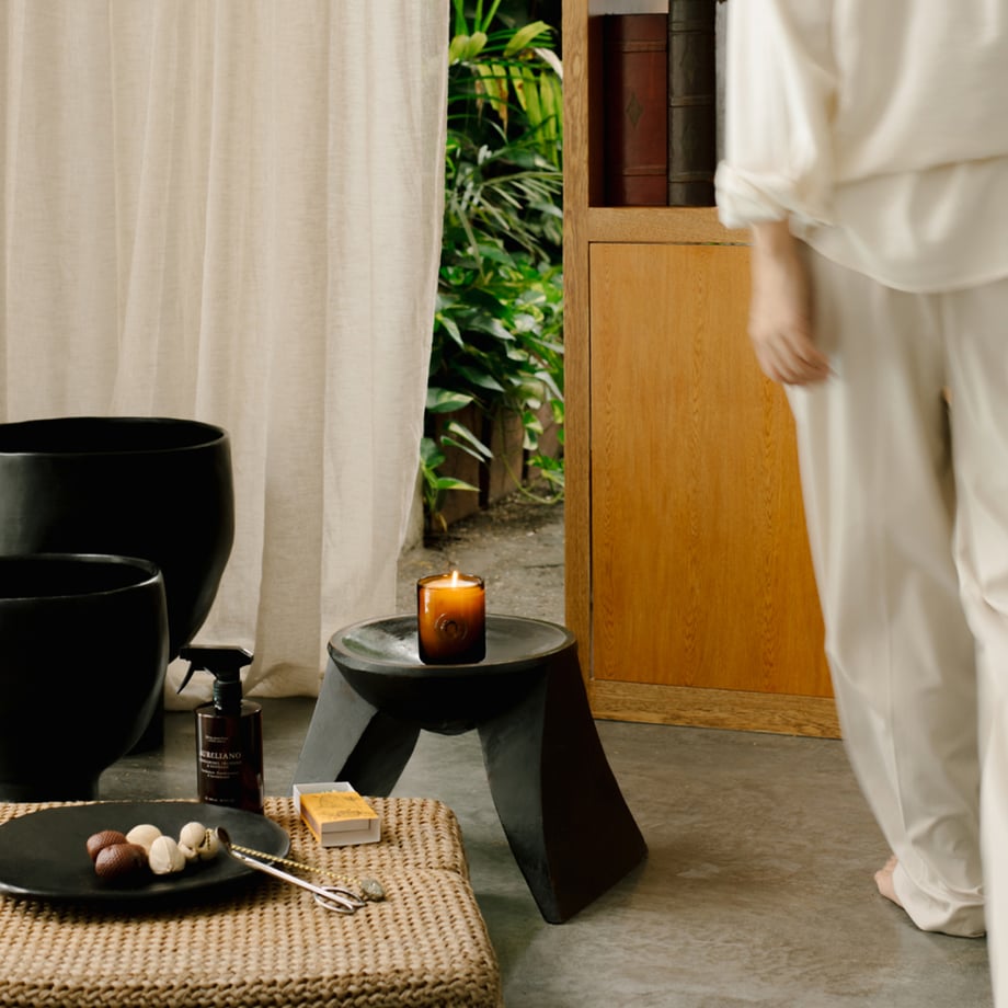 image of a  lady walking past a candle